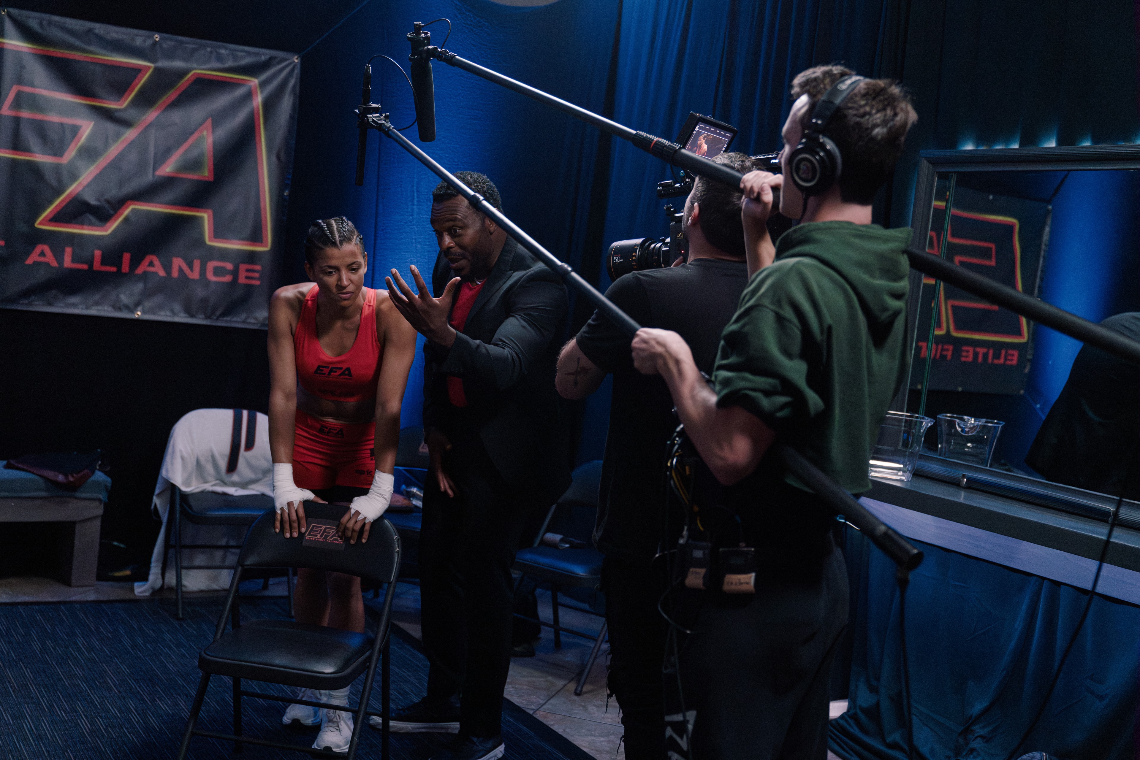 Cast and crew filming a scene on The Last Round set