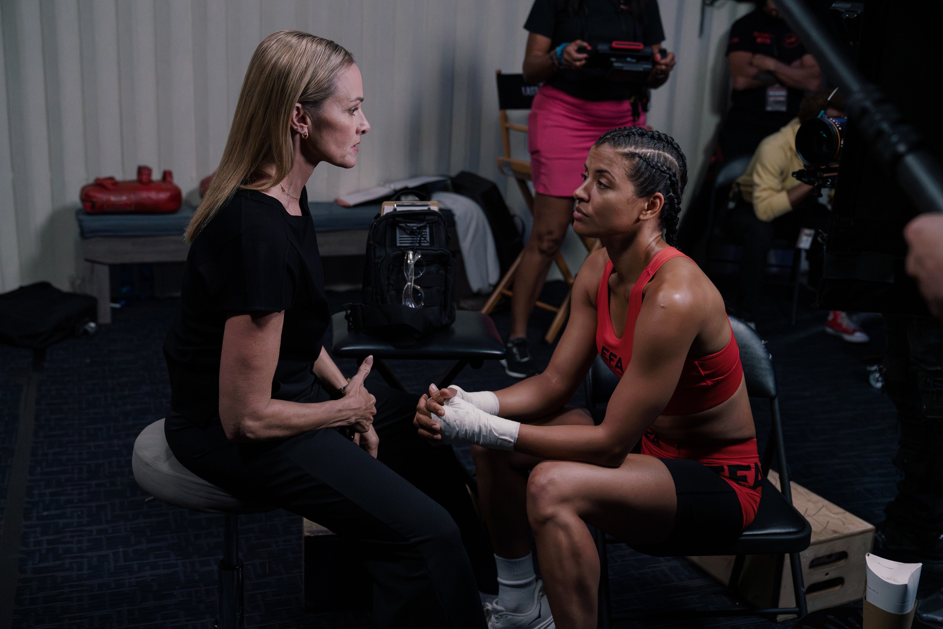 Director speaking with the fighter between takes on The Last Round set
