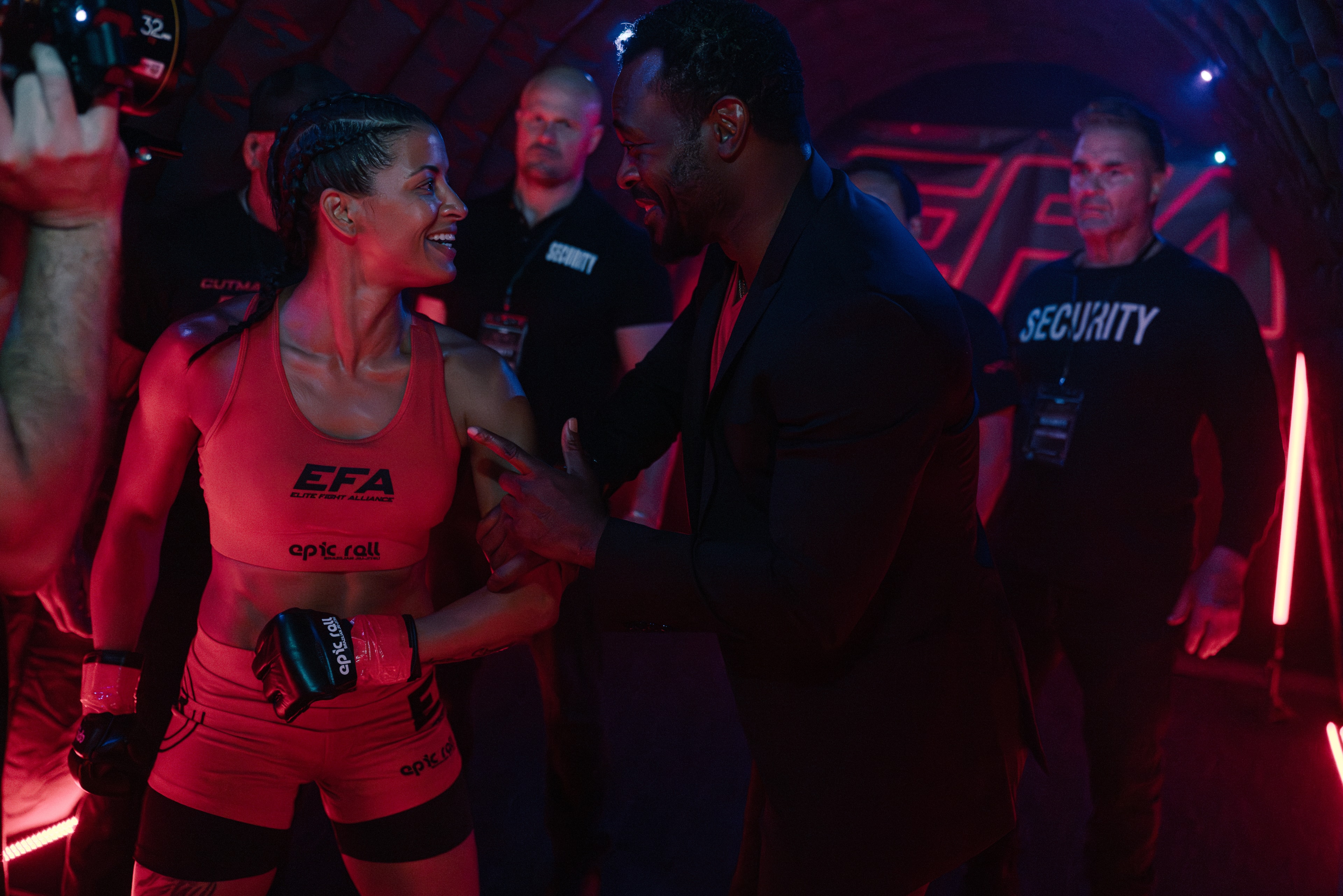 Fighter and coach preparing under blue light on The Last Round set